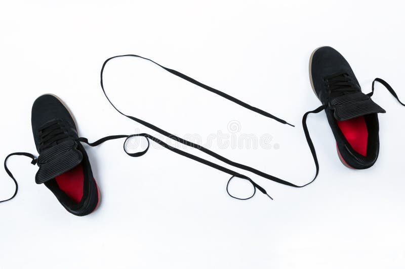 Skateboard shape created of shoe laces on white background