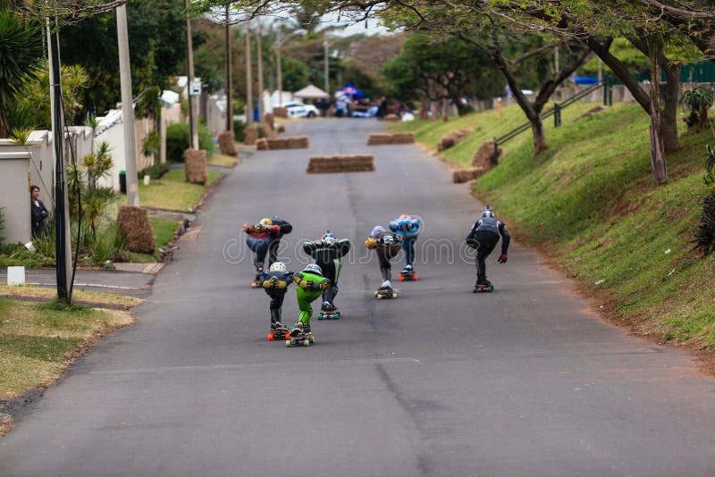 Street Kings skateboard downhill long-boarding race event in Durban north on Danville Avenue South Africa. Photo image of racers all kitted out in leathers and helmets with skateboards racing downhill course. Street Kings skateboard downhill long-boarding race event in Durban north on Danville Avenue South Africa. Photo image of racers all kitted out in leathers and helmets with skateboards racing downhill course.