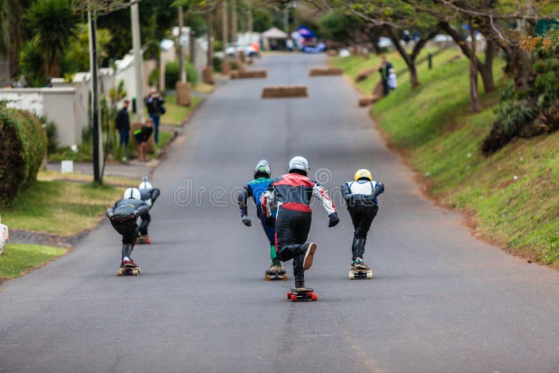 Street Kings skateboard downhill long-boarding race event in Durban north on Danville Avenue South Africa. Photo image of racers all kitted out in leathers and helmets with skateboards racing downhill course. Street Kings skateboard downhill long-boarding race event in Durban north on Danville Avenue South Africa. Photo image of racers all kitted out in leathers and helmets with skateboards racing downhill course.