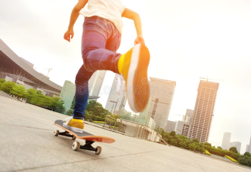 Young woman skateboarding at modern city. Young woman skateboarding at modern city