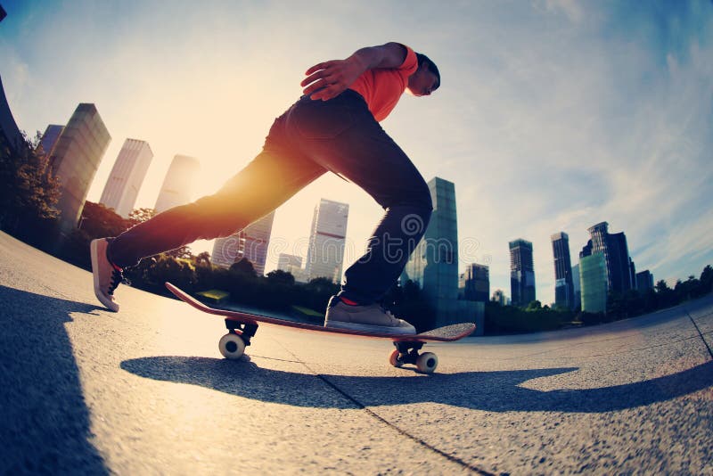 Skateboarding del skateboarder alla città di alba fotografia stock Skateboarding del skateboarder alla città di alba fotografia stock