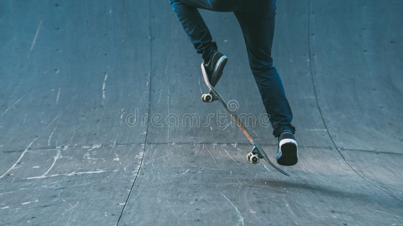 Skateboarding hobby. Man active life. Guy on skateboard performing ollie trick on ramp. Copy space. Skateboarding hobby. Man active life. Guy on skateboard performing ollie trick on ramp. Copy space.