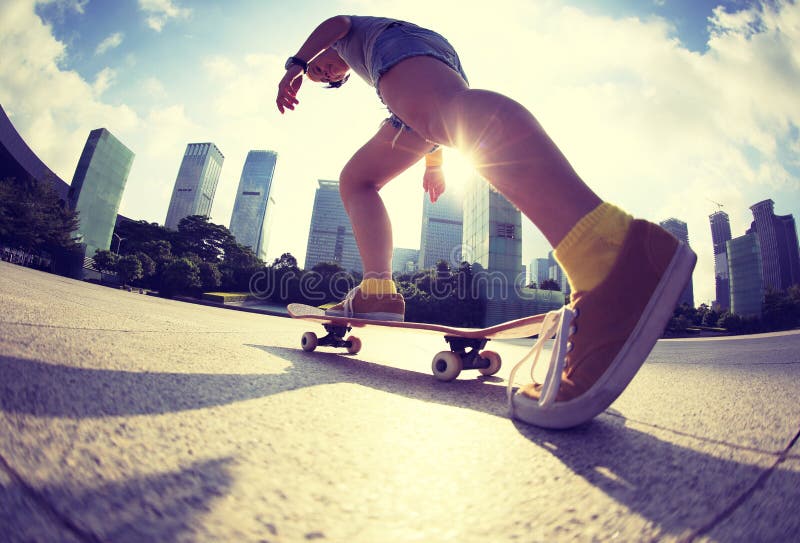 Skateboarder skateboarding at sunrise city