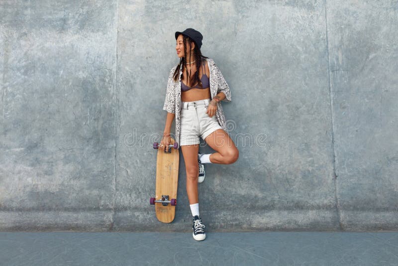 Skater Girl at Skatepark. Full-Length Portrait of Female Hipster in Casual  Outfit with Skateboard Against Concrete Wall. Stock Photo - Image of board,  portrait: 195692974