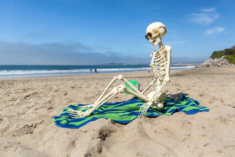 skeleton-beach-towel-relaxing-sand-coast