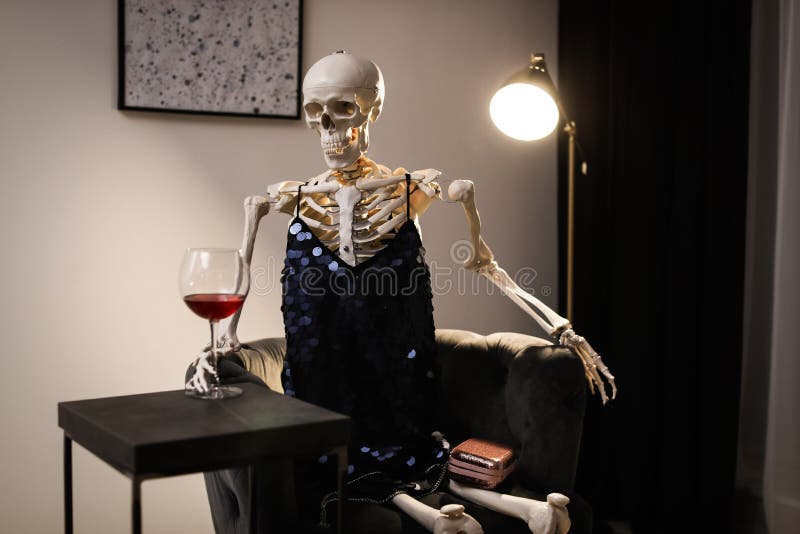 Skeleton in Dress with Wine Sitting at Table Stock Photo - Image of skeleton,  concept: 169980636