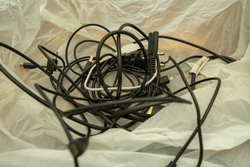 Cable Management. Working Wires, Black Cables Wound into a Coil, a