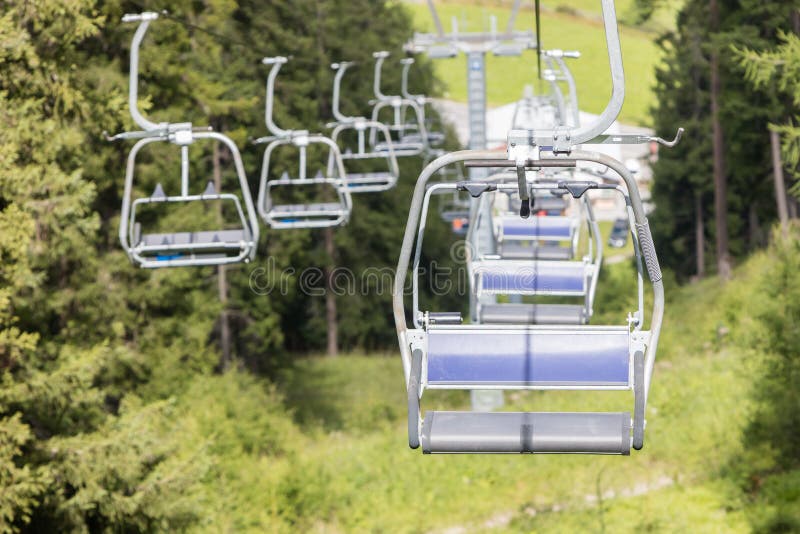 Ski lift chair in the Alps. Forest, peaceful.