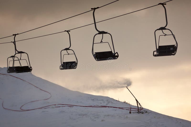 Ski lift line and working artificial snow gun