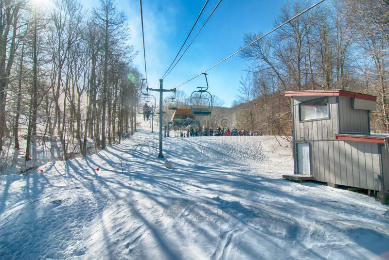 Ski lift with seats going over the mountain