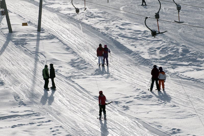 T bar ski lift pulling skier up the slope stock image T bar ski lift pulling skier up the slope stock image