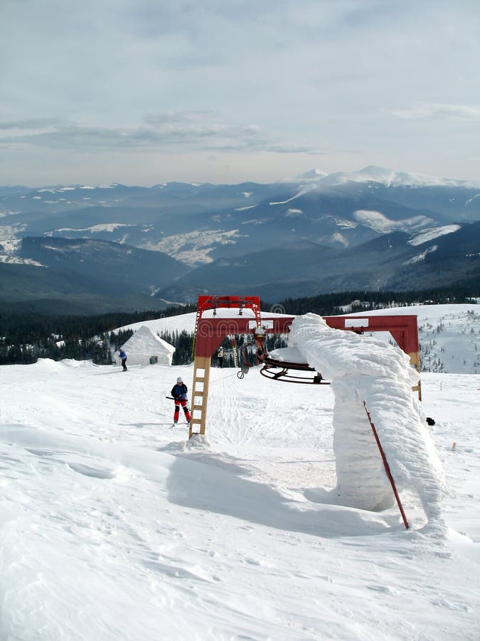 Ski lift on snow covered mountain peaks on high. royalty free stock images Ski lift on snow covered mountain peaks on high. royalty free stock images