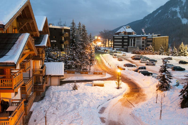 Snow covered streets and chalets in a French ski resort after sunset. Snow covered streets and chalets in a French ski resort after sunset.