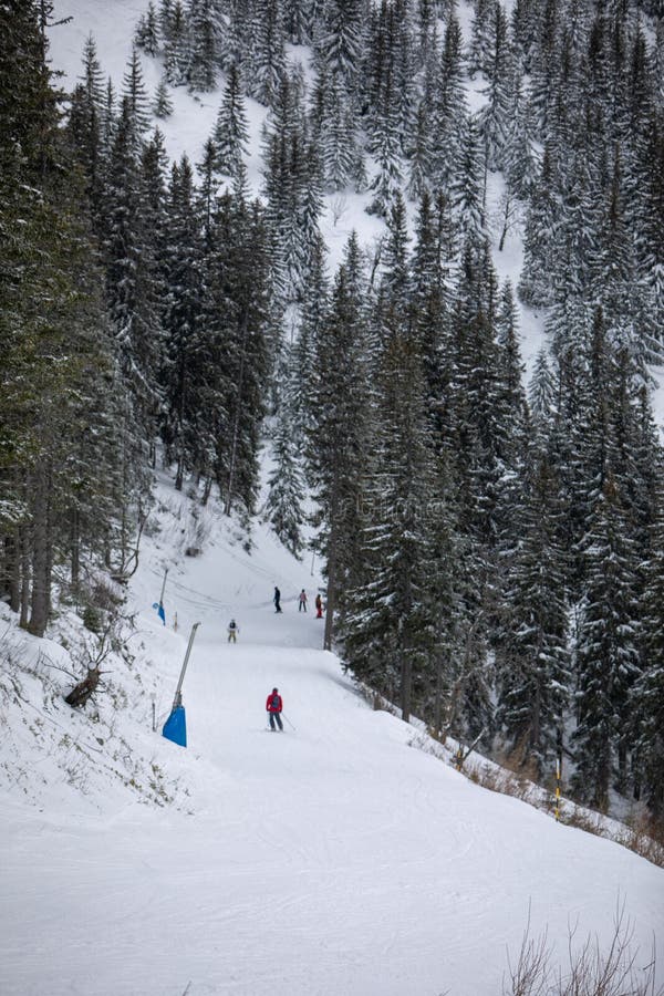 Ski slope with people on winter vacation