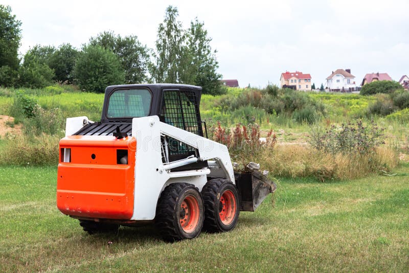 A Skid Steer Loader Clears the Site for Construction. Land Work by the Territory Improvement
