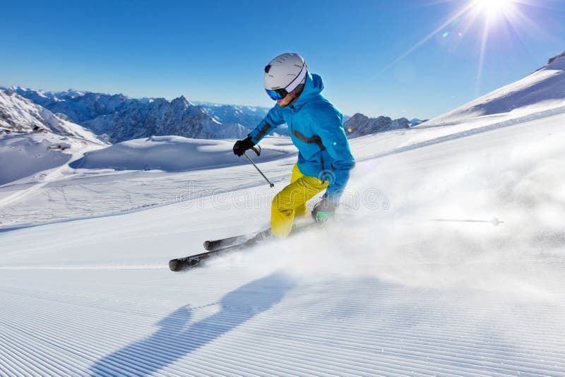 Skier on piste running downhill