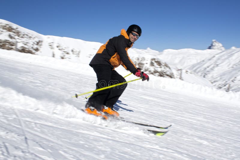 Skier going down the hill stock photo. Image of snow 69976706