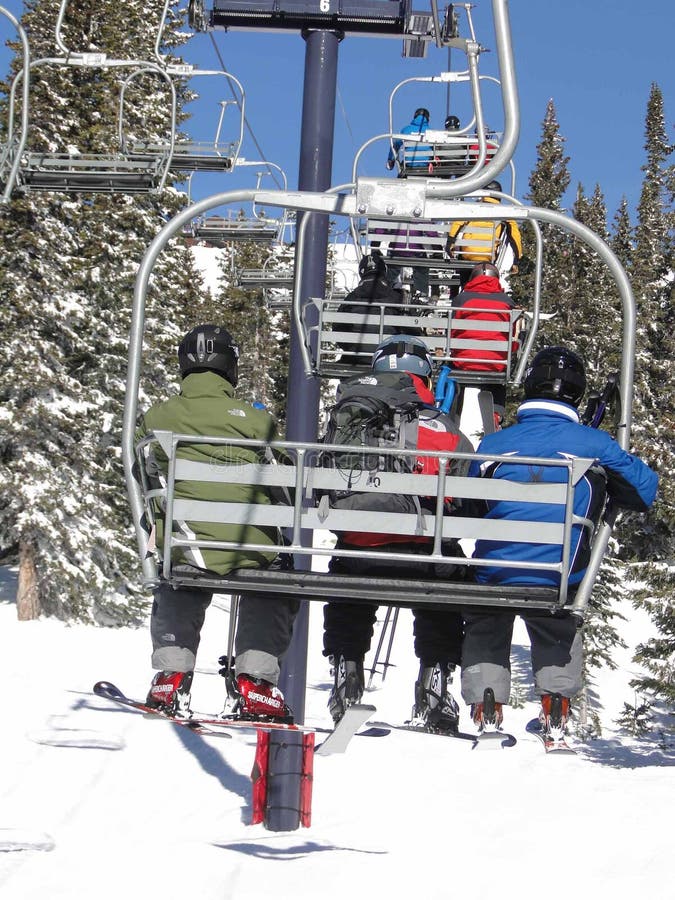 Skiers Ride the Chairlift through a Spruce Forest Editorial Image
