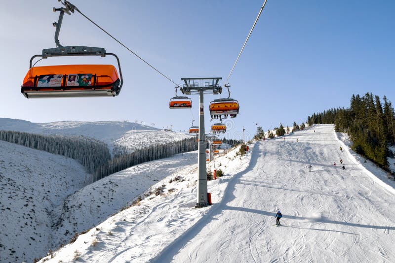 Skiers on slope in and ski lift chair at resort Jasna, Slovakia