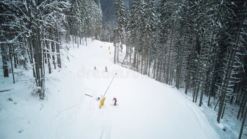 Skiers and snowboarders go down the slope in a ski resort Bukovel, Ukraine stock image Skiers and snowboarders go down the slope in a ski resort Bukovel, Ukraine stock image