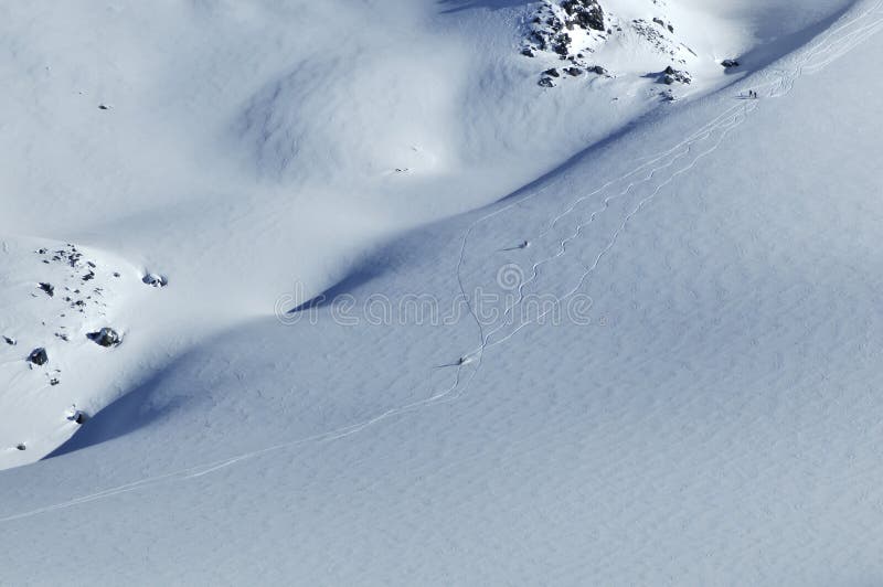 2 skiers skiing on a glacier in fresh powder snow. 2 skiers skiing on a glacier in fresh powder snow