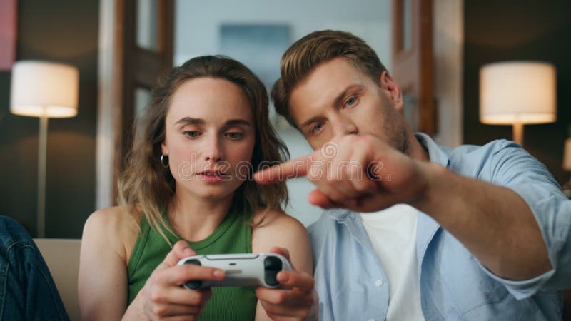 Man gamer teaching his girlfriend playing space shooter video game Stock  Photo by ©DragosCondreaW 465086788