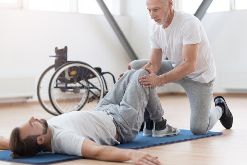 Aged Orthopedist Working with Handicapped in the Gym Stock Image ...