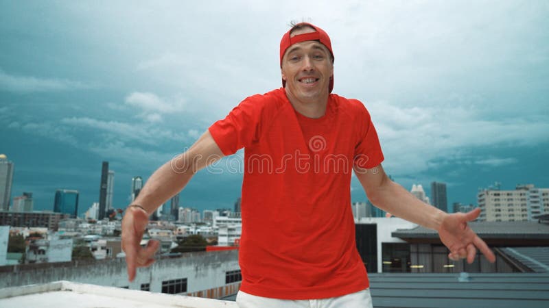 Skilled hipster looking at camera while standing at sky scrapper view. Hiphop. stock photo