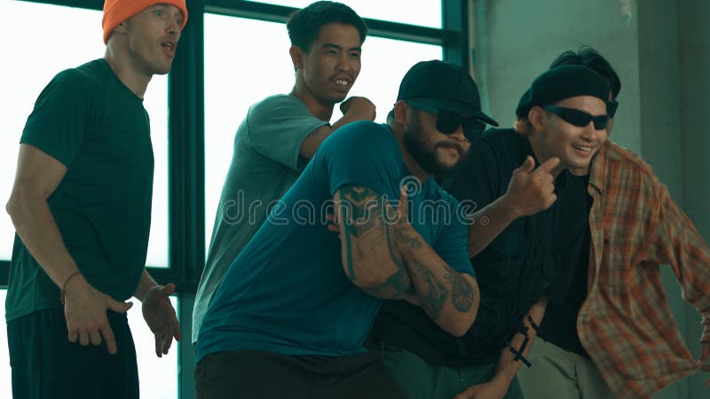 Skilled hipster pose at camera with multicultural friend at building. Endeavor. stock image