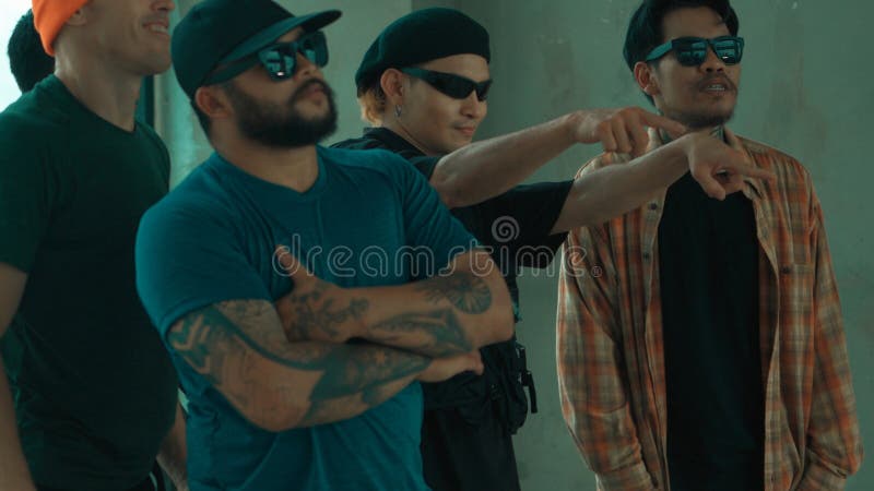 Skilled hipster pose at camera with multicultural friend at building. Endeavor. stock image