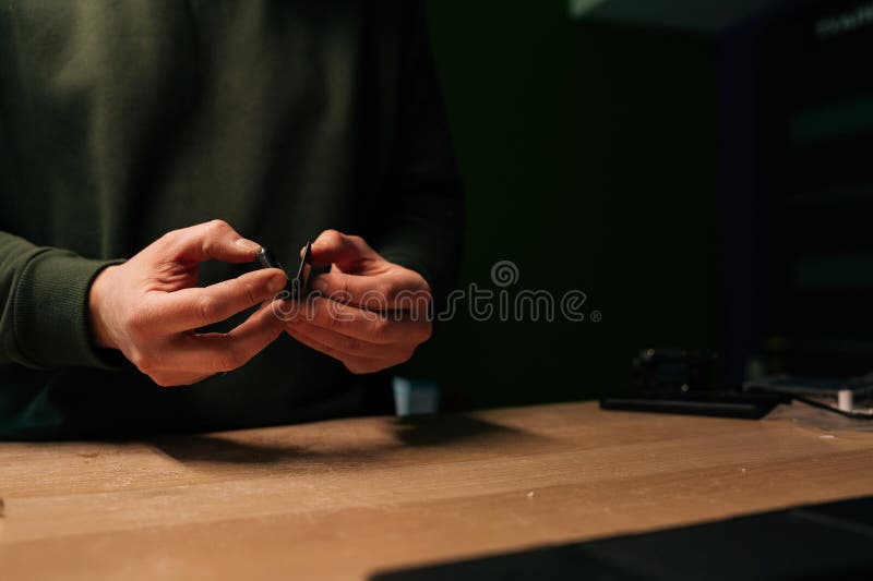 Skilled technician preparation to replacement smartwatch battery, showing precision workmanship during delicate stock image