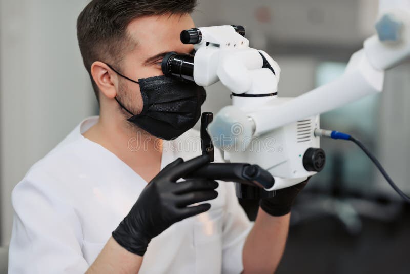 Skilled User. Handsome Young Male Dentist Looking into the Lens of a