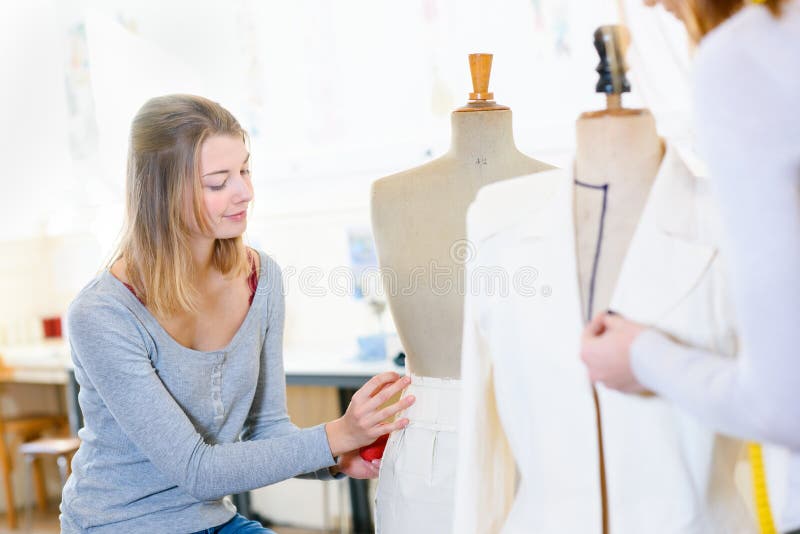 Skillful female dressmaking adjusting buttons on clothing royalty free stock photos Skillful female dressmaking adjusting buttons on clothing royalty free stock photos