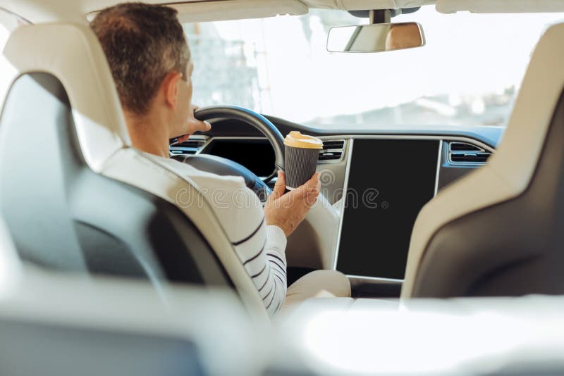 Skillful Professional Driver Sitting Behind the Wheel Stock Photo
