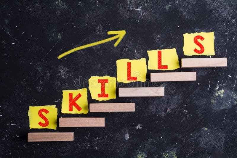 Skills word in yellow paper on wooden steps with arrow on black grunge background. Skills word in yellow paper on wooden steps with arrow on black grunge background