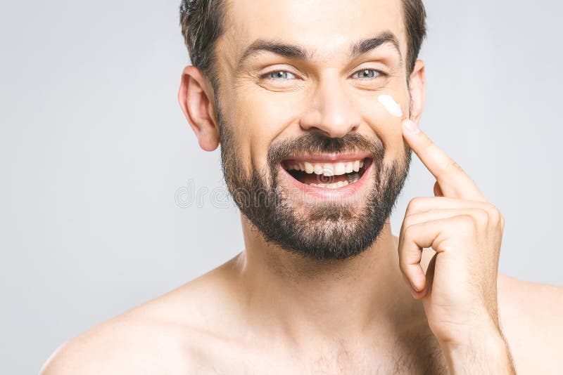 Skin Care Handsome Happy Young Shirtless Man Applying Cream At His 