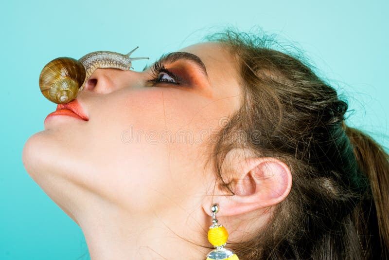Skin care. Massage with snail. Skincare repairing. Healing mucus. Having fun with adorable snail. Cosmetics and snail stock photos Skin care. Massage with snail. Skincare repairing. Healing mucus. Having fun with adorable snail. Cosmetics and snail stock photos