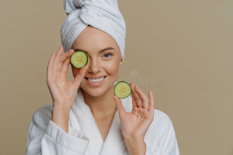 Positive Refreshed Beautiful Woman Holds Slices of Fresh Cucumber Makes ...