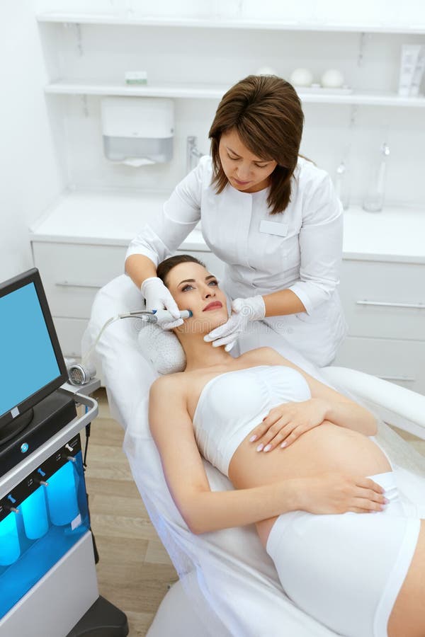 Skin Care. Pregnant Woman On Face Cleansing At Beauty Clinic