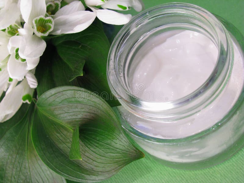 Skin cream and white spring flowers