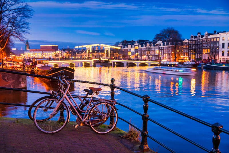 Skinny bridge and Amstel river in Amsterdam Netherlands at Dusk