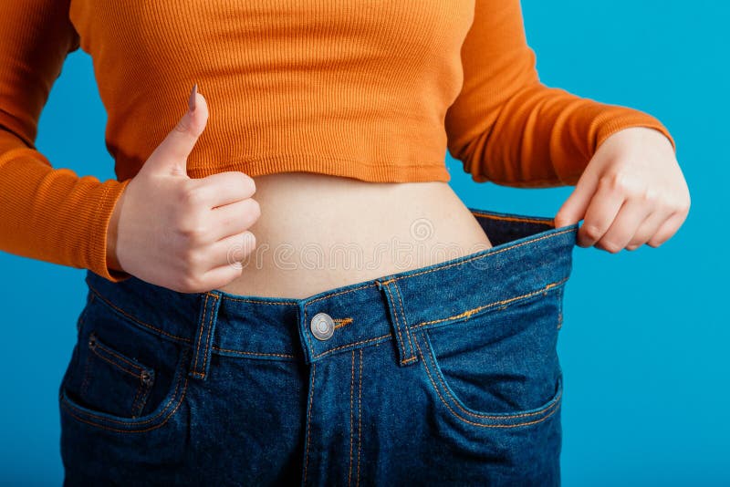 Skinny Weight Loss Woman Show Flat Stomach Pulling by Hands Oversized Big  Blue Pants Jeans Showing Thumbs Up Sign. Slim Body Low Stock Image - Image  of skinny, lost: 214863739