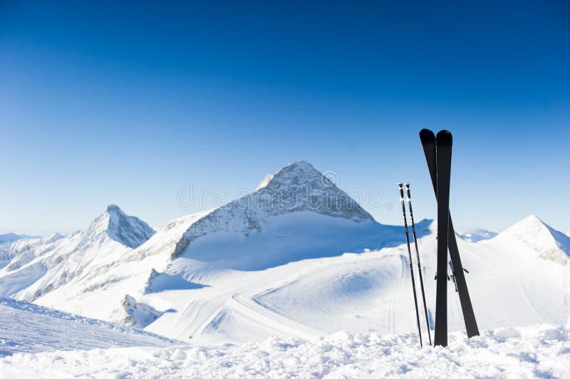 Skis in high mountains at sunny day