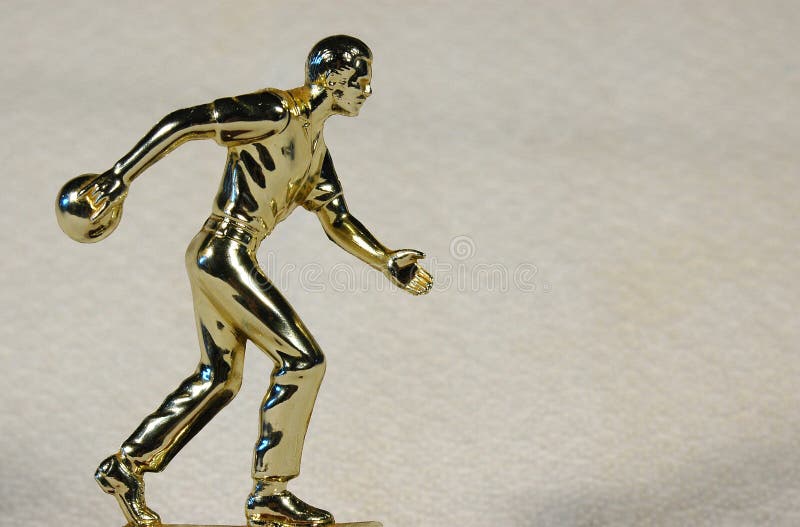 A golden trophy of a skittle player for first place winner in bowling sport. A golden trophy of a skittle player for first place winner in bowling sport