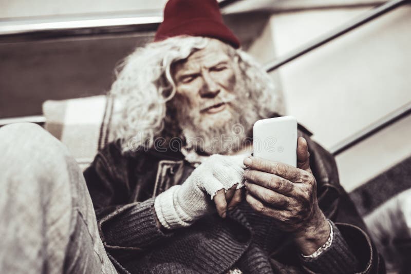 Finally, send. Concentrated Caucasian almsman sitting relaxedly and typing message to his friend. Finally, send. Concentrated Caucasian almsman sitting relaxedly and typing message to his friend.