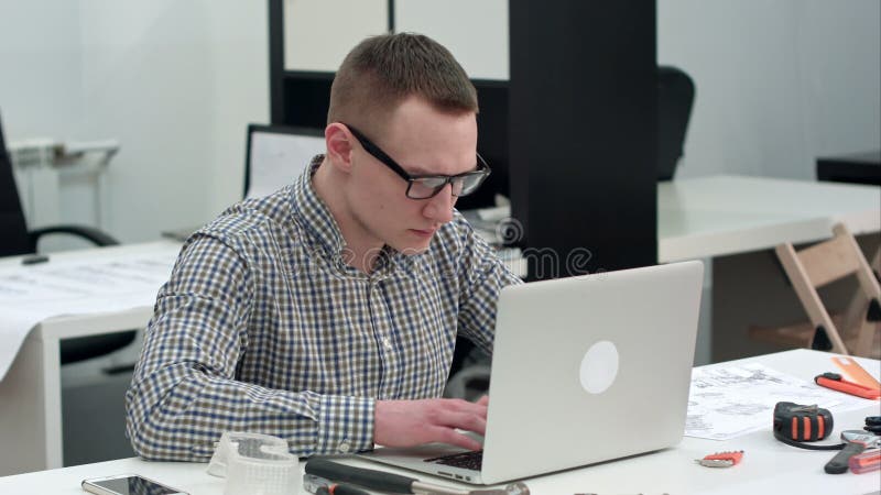 Skoncentrowany architekt projektuje nowego projekt na laptopie zbiory wideo