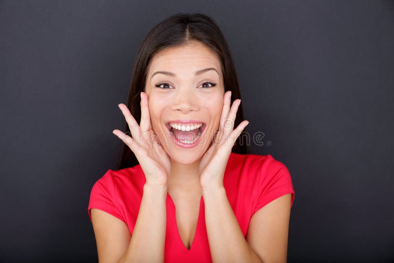 Screaming girl on black background yelling excited, happy and loud looking at camera. Young casual woman wearing red t-shirt. Multi-ethnic mixed race Asian Caucasian female girl model in studio. Screaming girl on black background yelling excited, happy and loud looking at camera. Young casual woman wearing red t-shirt. Multi-ethnic mixed race Asian Caucasian female girl model in studio.