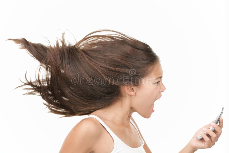 Screaming angry woman on the mobile phone. Dynamic and energetic image of young mixed race chinese / caucasian woman isolated on seamless white background. Screaming angry woman on the mobile phone. Dynamic and energetic image of young mixed race chinese / caucasian woman isolated on seamless white background.