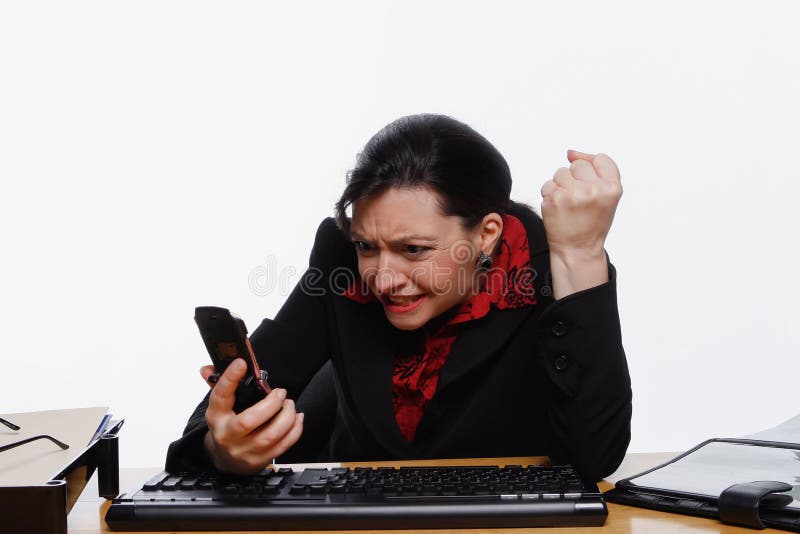 Business woman screaming at her cell phone. Isolated against a white background. Business woman screaming at her cell phone. Isolated against a white background