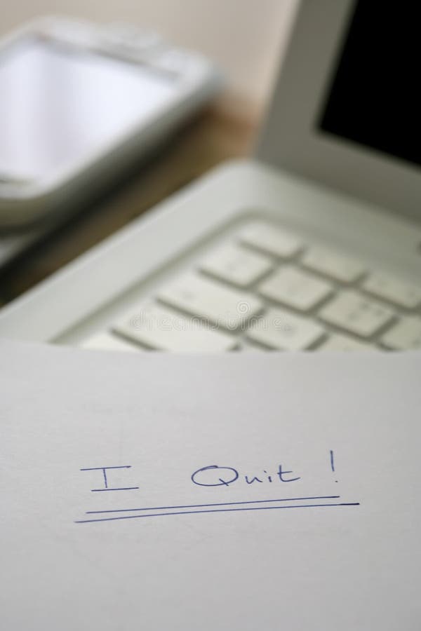 I quit, resignation note on a desk in an office environment. I quit, resignation note on a desk in an office environment.